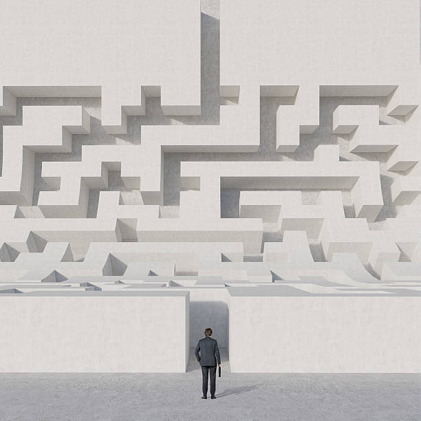 istock businessman looking at maze 477419186