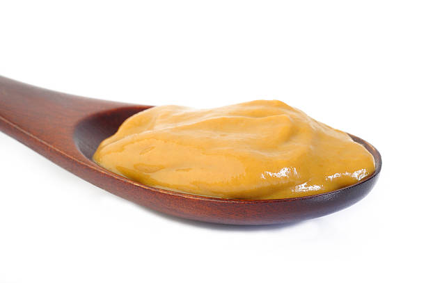 istock Mustard sauce in wooden spoon 477419826