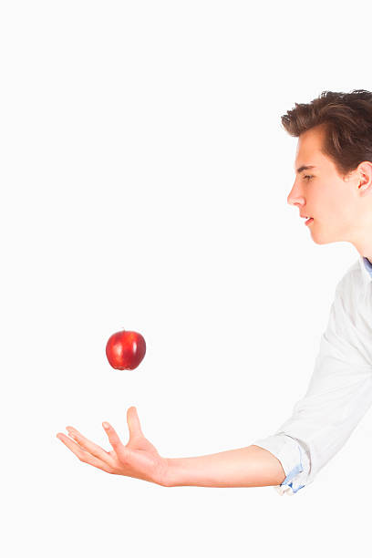 istock Man Tossing Red Apple in the Air 477420144