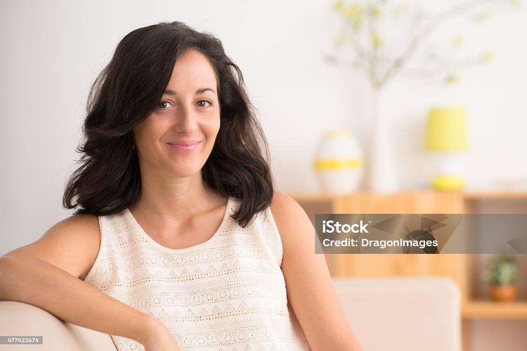 Brunette Portrait of a mid-adult woman sitting at home 30-39 Years Stock Photo