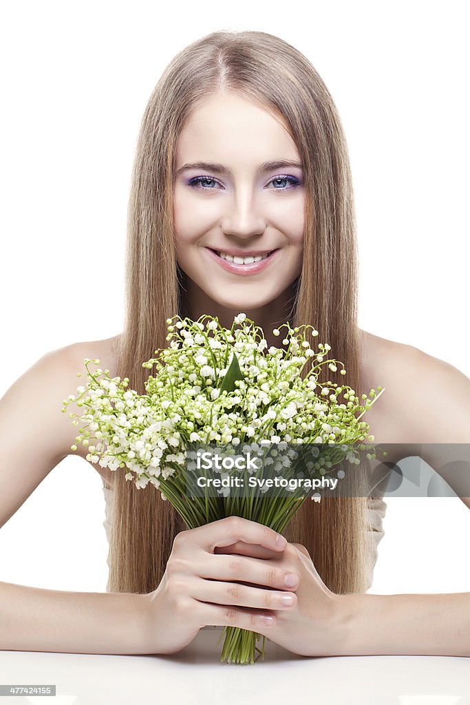 Woman with lily of the valley Young beautiful blond woman holding lilies of the valley Adult Stock Photo