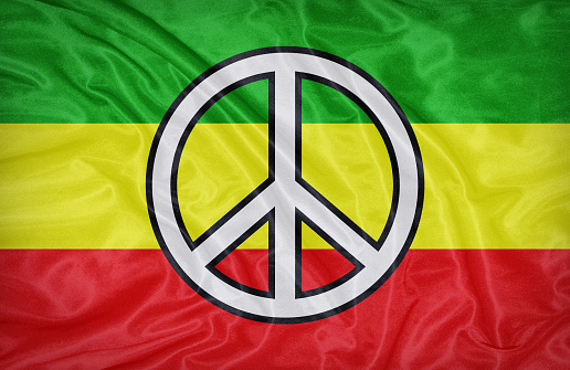 Rasta flag pattern with a peace on fabric texture,retro vintage style
