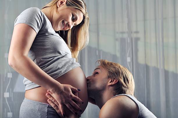 istock Happy future daddy kissing his unborn baby boy 477427390