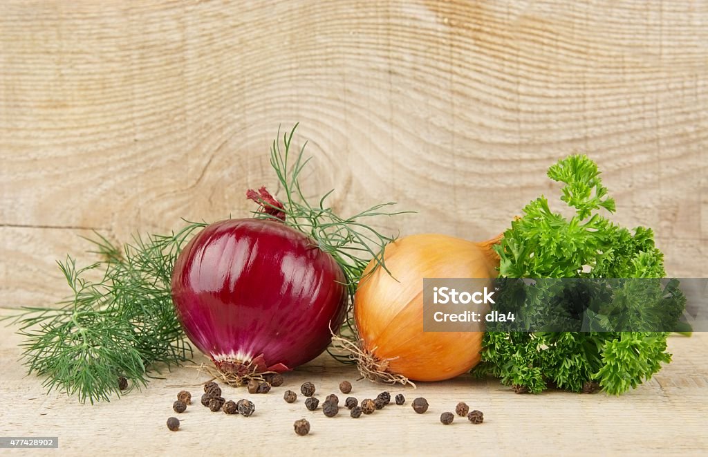 Onion,red onion,dill,parsley,pepper on wooden plank Onion,red onion,dill,parsley,allspice and black pepper on wooden background 2015 Stock Photo