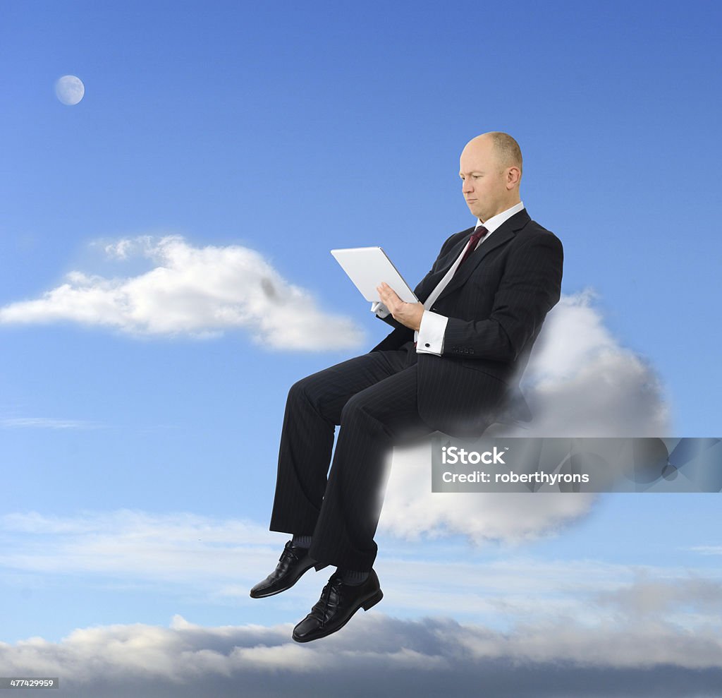 wireless access a businessman sitting on a cloud with a tablet pc Accessibility Stock Photo