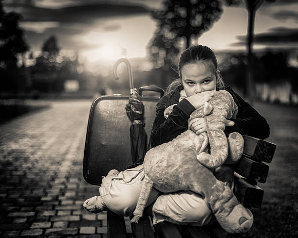 little girl sit alone at the house stairs.