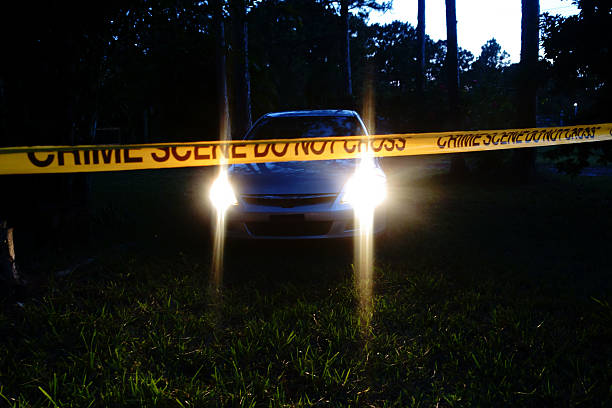 istock Car at crime scene in rural area at night 477430732