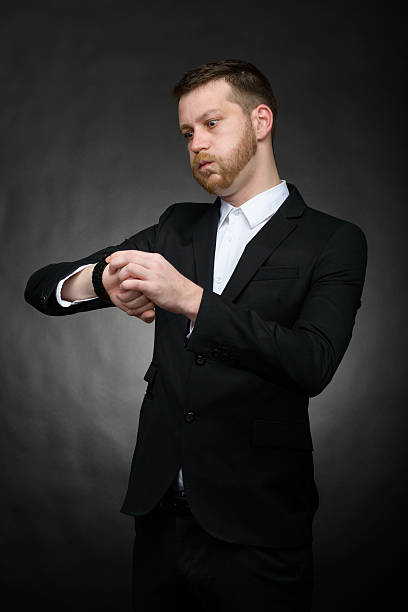 istock businessman looking worried at watch 477433251