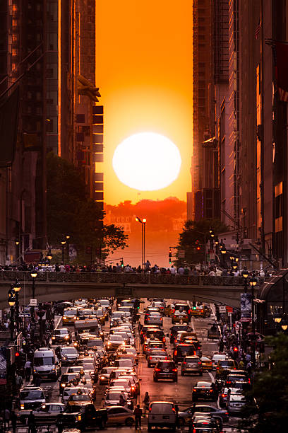 Manhattanhenge in New York City, along the 42nd street. Manhattanhenge is an event during which the setting sun is aligned with the main street grid of Manhattan, New York City