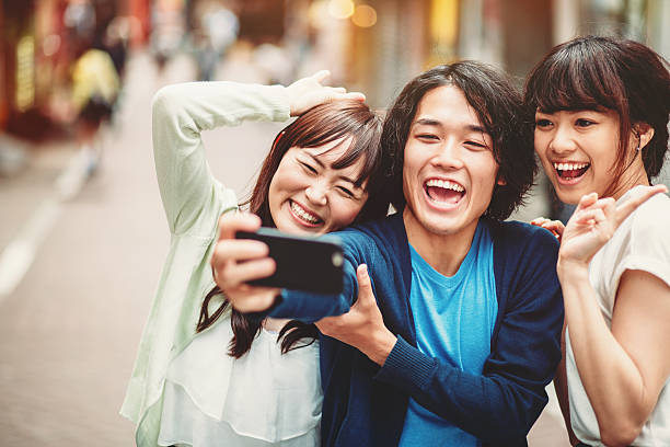 istock Group of young japanese people making selfie 477434194