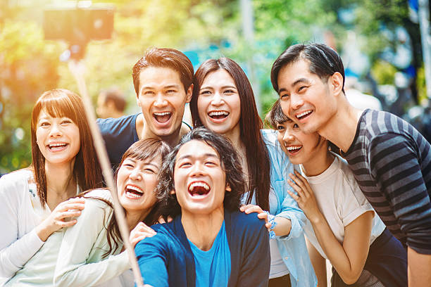 istock Group of young japanese people making selfie 477434204