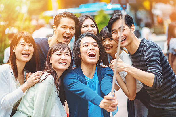 istock Group of young japanese people making selfie 477434208