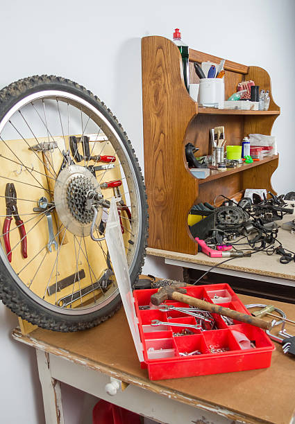 istock Wheels and bicycle parts over workshop table 477434305