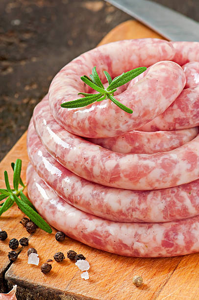 istock Fresh raw sausage on the old wooden background 477434529