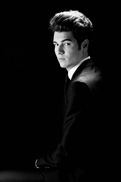 istock Young businessman, isolated on black background 477437343