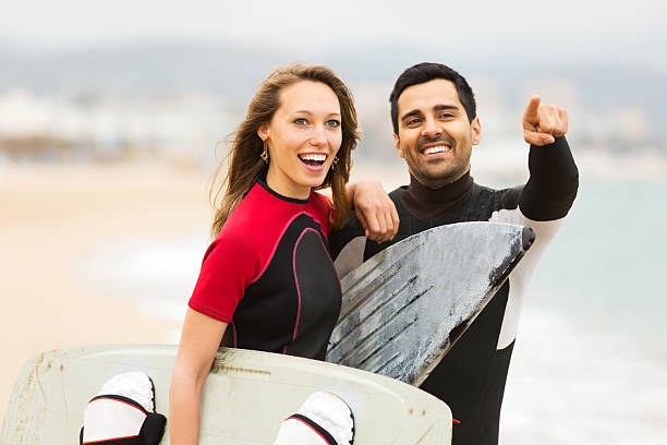 istock Happy couple with surf boards 477438828