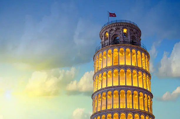 Tower of Pisa in Miracles Square, Illuminated at Night with sunset, Italy