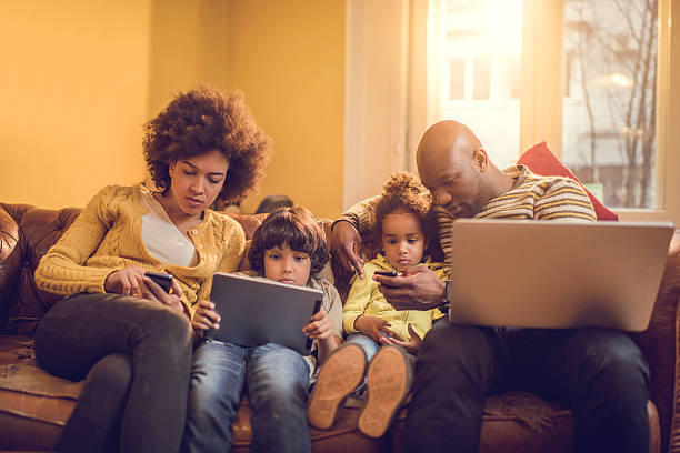istock African American family using wireless technology at home. 477440140