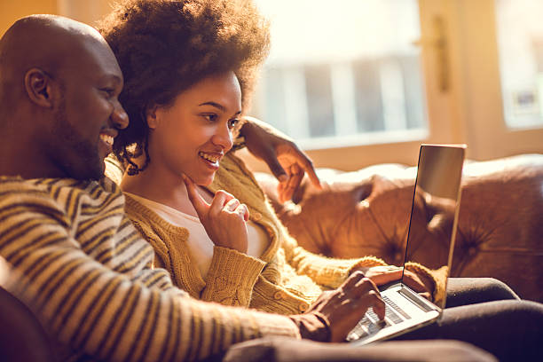 istock Young happy African American couple using laptop together. 477440162