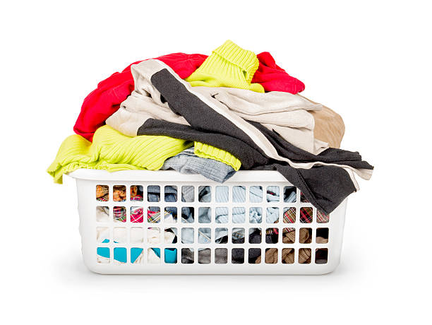 istock Bright clothes in a laundry basket on white background 477440390