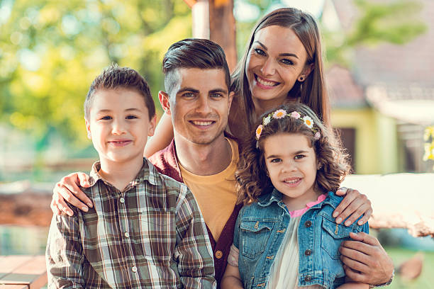istock Happy young family looking at camera during springtime. 477441364