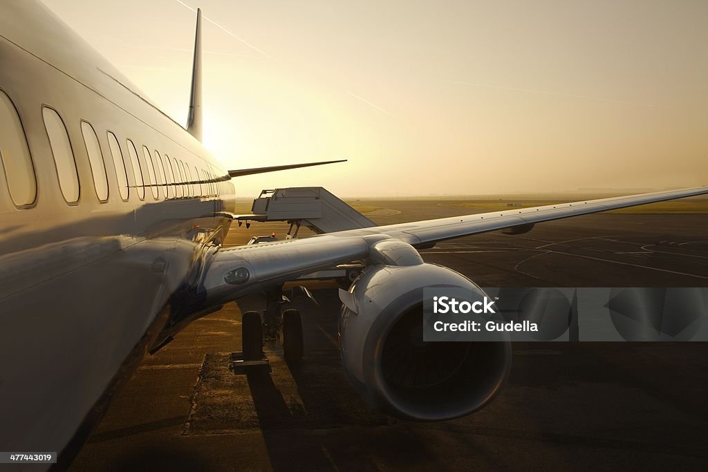 Airliner Airplane at an airport at sunrise Airplane Stock Photo