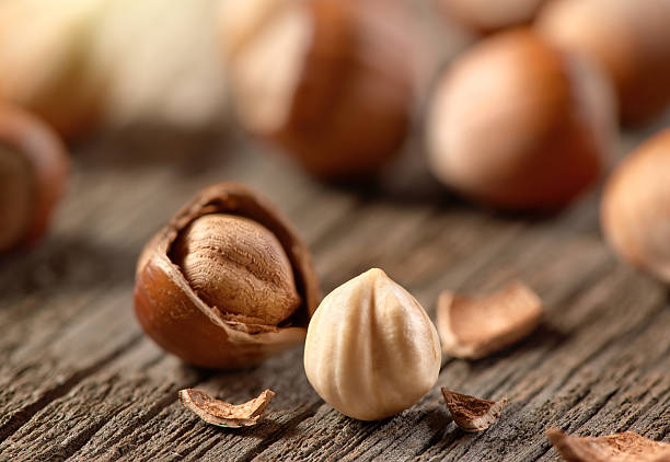 Hazelnuts, filbert on old wooden background Hazelnuts, filbert on old wooden background hazel tree stock pictures, royalty-free photos & images