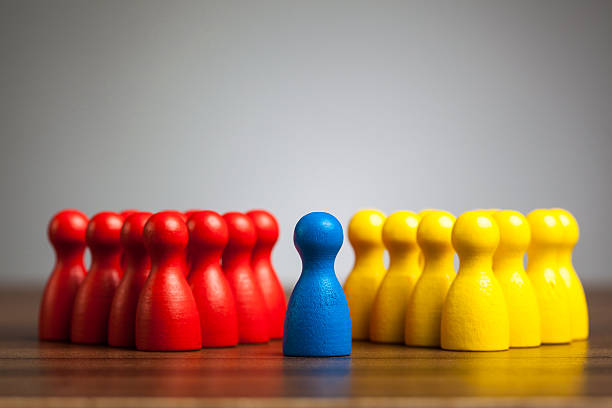 Single blue pawn figure between red and yellow groups