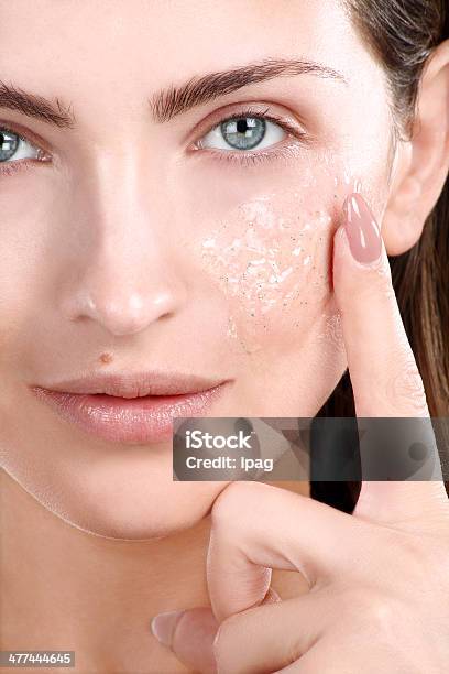 Beautiful Woman Applying Scrub Treatment On Face Stock Photo - Download Image Now - Essential Oil, Human Face, Women