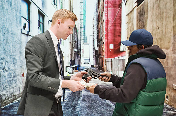 istock Businessman buying pistol 477445178