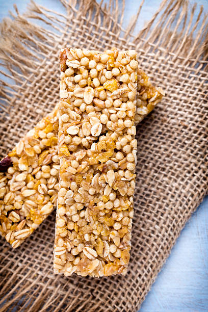 istock Muesli bars, cereal bars on the wooden background. 477446028