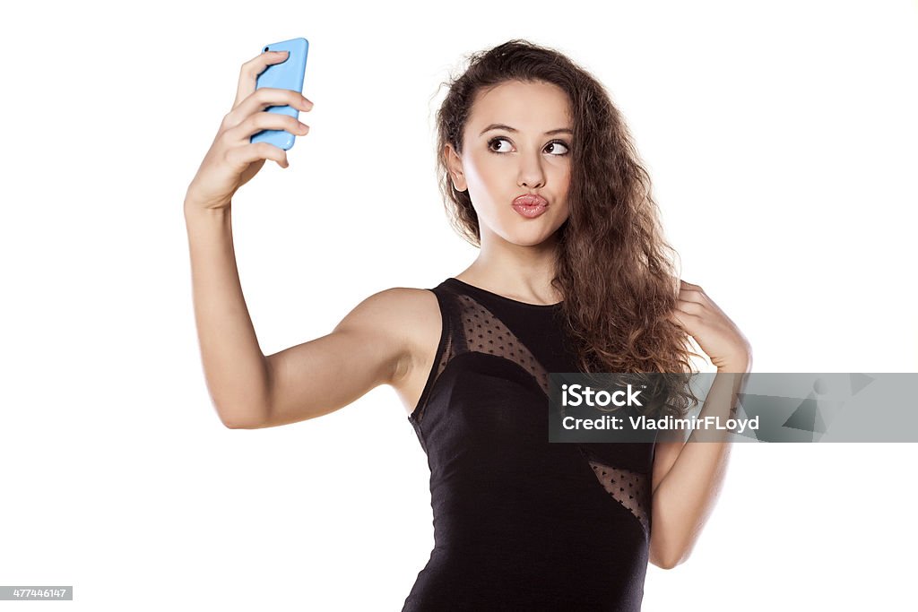 selfies pretty teen girl taking selfies with her smart phone Adult Stock Photo