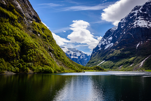 Early springtime in Naeroyfjord, a tributary of the giant Sognefjord. The narrow fjord is know for steep mountainsides, waterfalls, snow fields, and picturesque farms and hamlets. It is a major attraction of western Norway and is listed on the UNESCO World Heritage List.