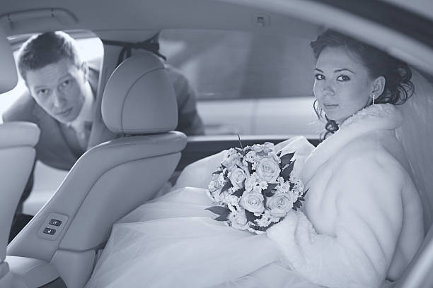istock bride and groom in car 477449784