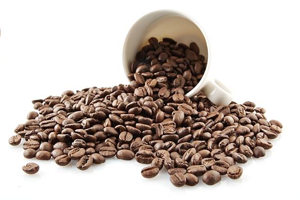 istock Overturned cup full of coffee beans on white 477450090