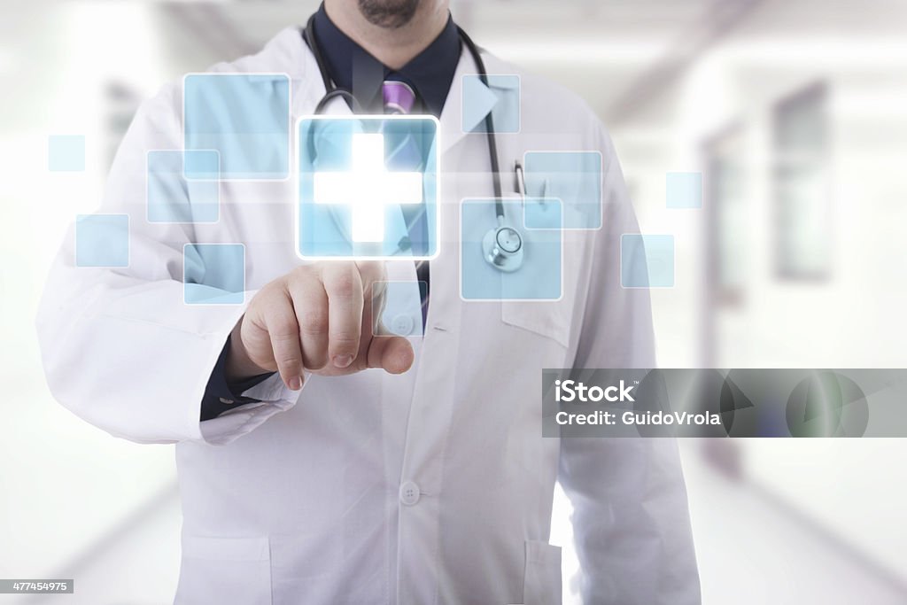 Medical touchscreen Male doctor working on a futuristic touchscreen display Care Stock Photo