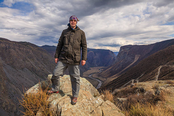 Happy man on the top of a high mountain