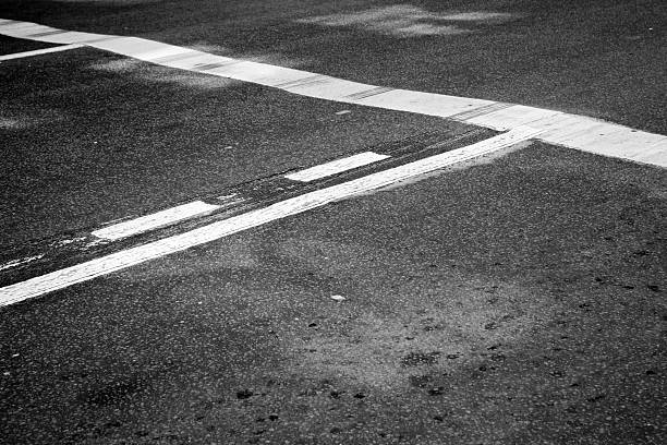 istock Asphalt road with stop line and tire tracks 477455372