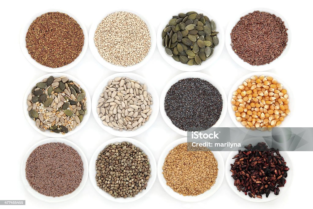 Healthy Seeds Healthy seed selection in porcelain bowls over white background. Bowl Stock Photo