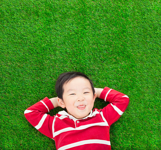 istock funny kid lying and holding his head 477456511