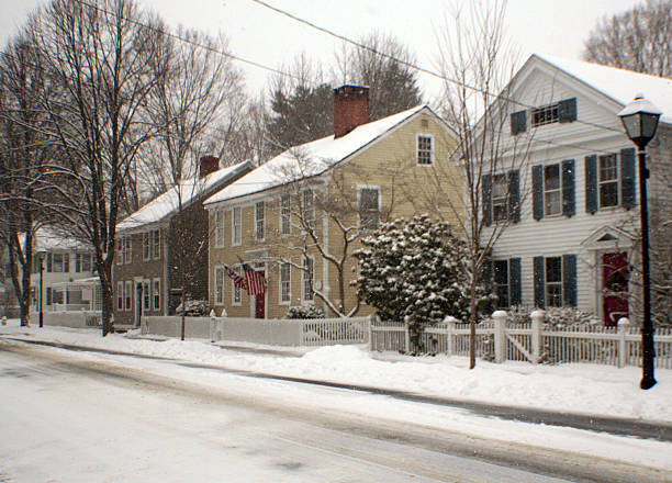 Small American Town 17th C Architecture Main Street Winter View of residential block of Main Street w/traditional 17th Century Architecture captured with a wide angle lense during a snow storm. (see my blog) essex stock pictures, royalty-free photos & images