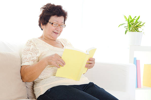 istock Asian senior woman reading 477458334