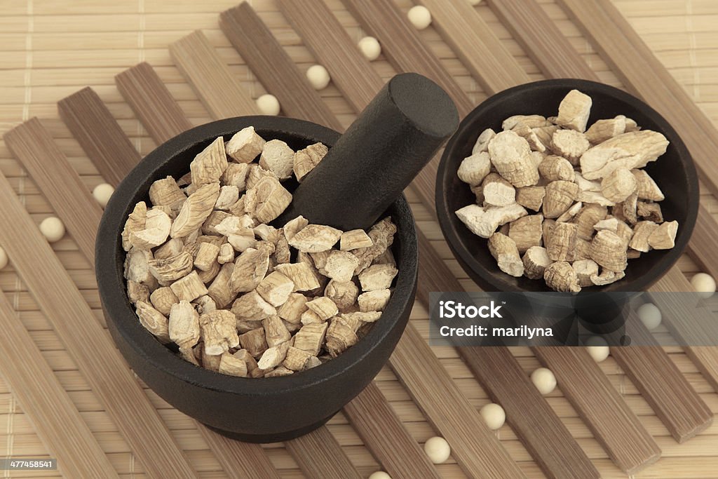 Korean Ginseng Korean ginseng chinese herbal medicine in a mortar with pestle and bowl. Panaz schinsen. Ren shen. Alternative Medicine Stock Photo