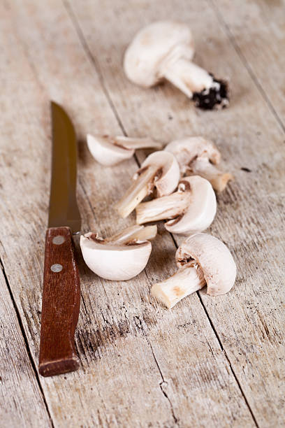 istock fresh sliced champignons and old knife 477458661
