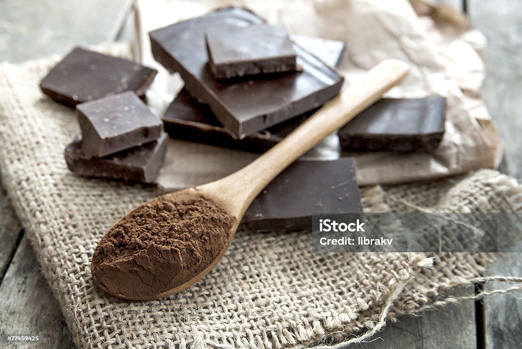 Cocoa Powder and Dark Chocolate Cocoa Powder and Dark Chocolate on table Dark Chocolate Stock Photo
