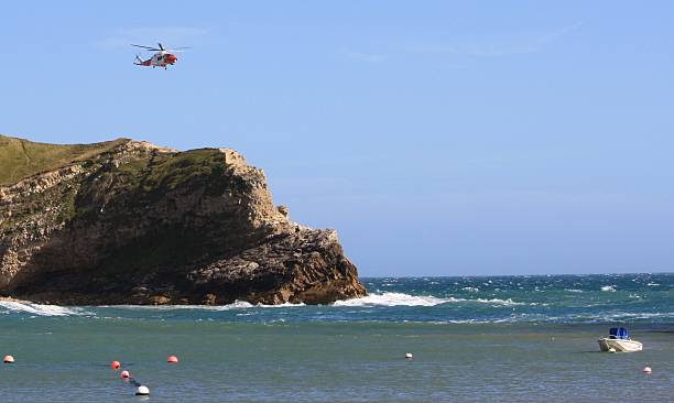 istock Rescue Helicopter over Lulworth Cove 477459761