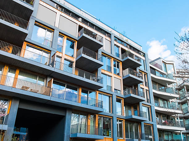 modern apartments with balconys and blue sky stock photo