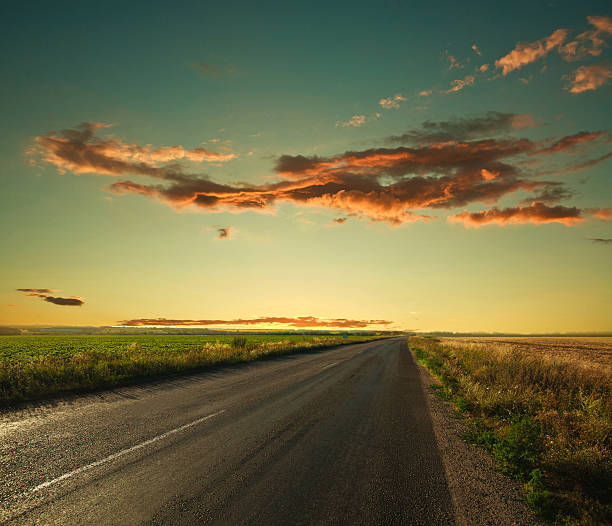 istock Lonely road leading to the horizon at sunset sky 477468363