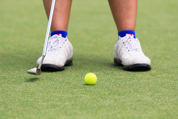 istock Woman golf player putting on the green 477468592