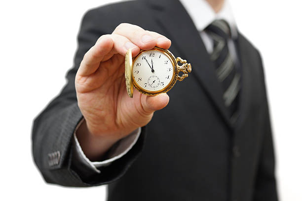 istock Businessman showing 5 minutes to twelve 477468931